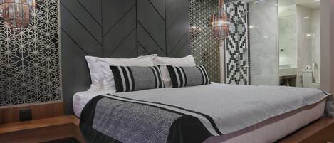 A modern bedroom with a bed, a nightstand, and a walk-in closet.