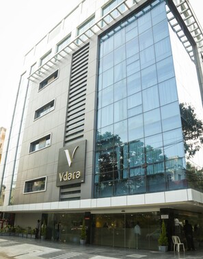 A modern building with a glass facade and the sign 'Vdara'. - Vybrant Hotels (Vijayawada)
