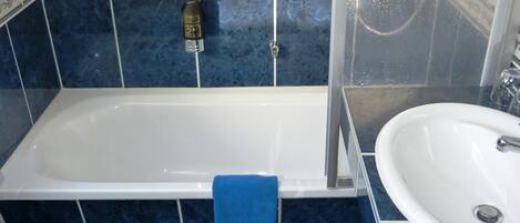 A bathroom with a bathtub, a sink, and a toilet.