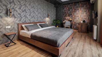 A modern bedroom with a wooden bed, a bookshelf, and a desk.