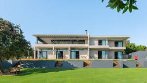 A modern two-story house with a flat roof, large windows, and a covered patio area. - Sunset Splendour Guesthouse (Cape Town)