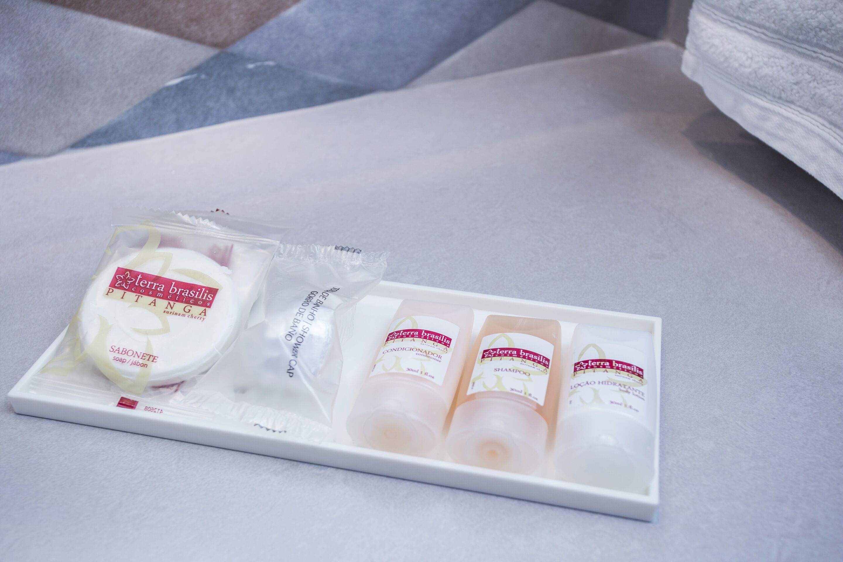 A tray with toiletries including soap, shampoo, and conditioner.