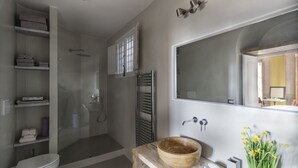 Une salle de bain moderne équipée d’une douche, de toilettes et d’un meuble-lavabo.