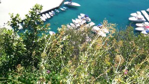 A coastal town with a marina, a large open amphitheater, and a beach area. - Castello Mezzacapo by Starhost (Scala)