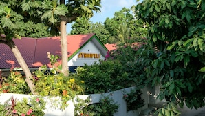 A building with a red roof and a sign that reads "ATHRIVELI". - Athiriveli (Thoddoo)