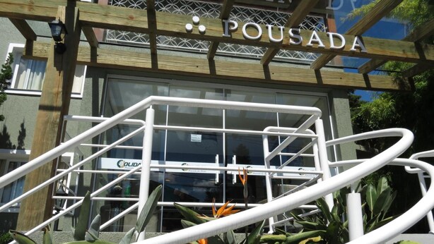 A building with a sign reading "POUSADA" and a metal railing in front. - Olidal Pousada da Serra (Gramado)