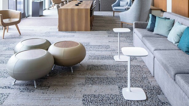 A modern hotel lobby with large windows, a wooden reception desk, and contemporary furniture. - Element by Marriott Bentonville (Bentonville)