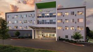 A modern building with a green roof and multiple windows, labeled 'element by WESTIN'. - Element by Marriott Bentonville (Bentonville)