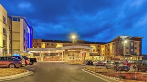 A hotel with a modern design, featuring a covered entrance and multiple parking spaces. - Residence Inn St Louis Westport (Maryland Heights)