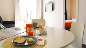 Una mesa de desayuno con un mapa, un vaso de zumo de naranja, un plato con tostadas y una taza de café.