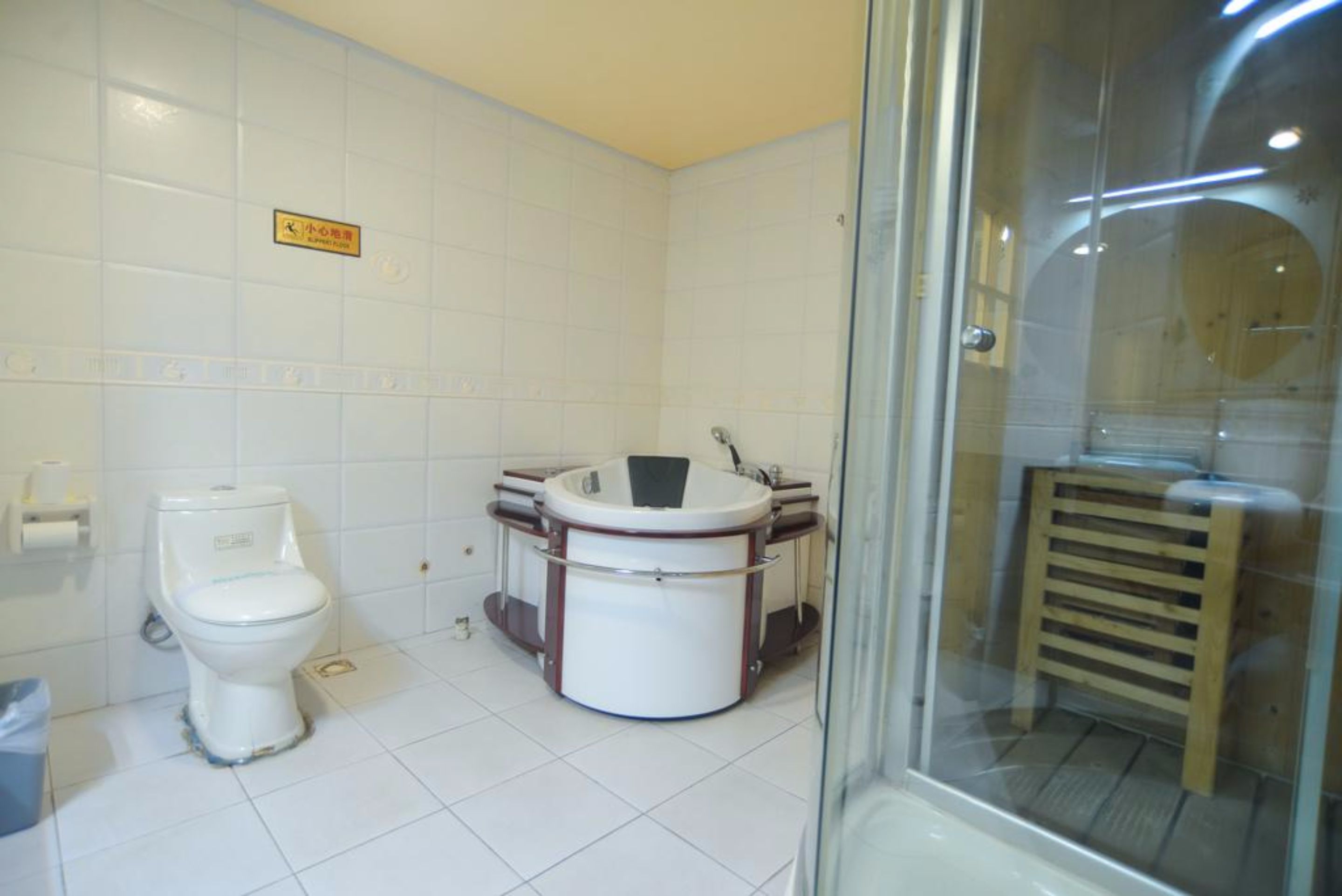 A bathroom with a toilet, a sink, and a glass shower enclosure.