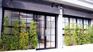 A modern building with large windows and a clean facade. - The Companion - Hostel (Bangkok)