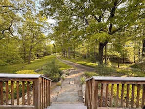 A pathway leading through a wooded area with a stone path and wooden railings on either side. - Private Woodstock / Saugerties 2BR w/ Hot Tub, Fireplace and Pet Friendly (Saugerties)