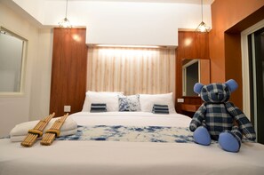 Deluxe Room with Balcony | Allergitestade sängkläder, minibar, skrivbord och mörkläggningsgardiner