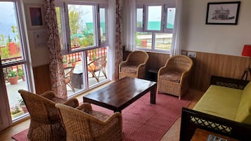 BROWN VILLA WITH A BIG PRIVATE SIT-OUT | Living area | 32-inch LCD TV with cable channels