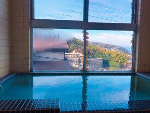 A swimming pool with a view of a building and trees. - Yamatoso - Hostel (Ito)