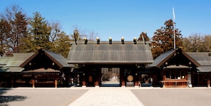 A traditional Japanese building with a central entrance, two side wings, and a flagpole. - Tokyu Stay Sapporo (Sapporo)