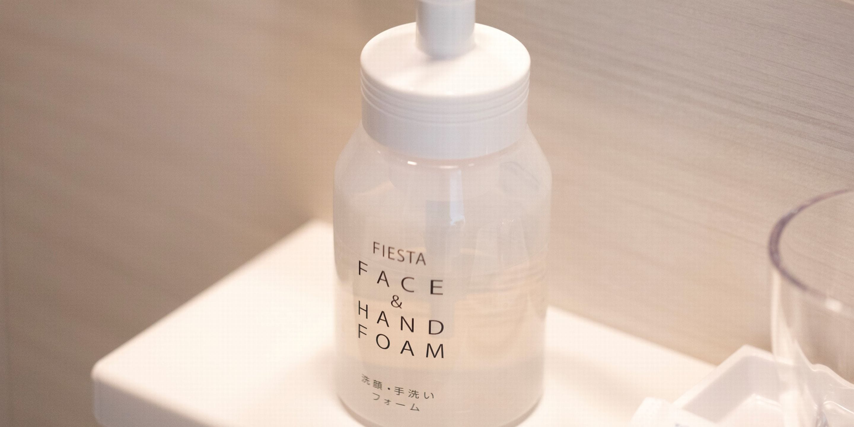 A bottle labeled "FIESTA FACE & HAND FOAM" on a white surface.