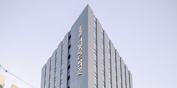 A modern building with a prominent vertical sign.