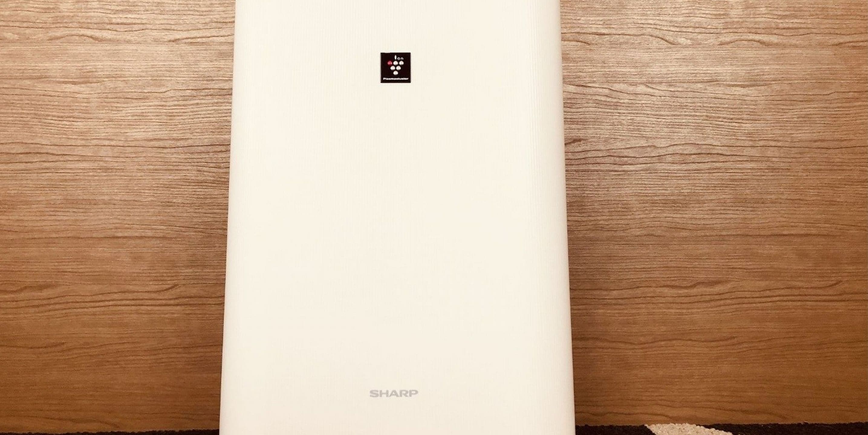A white Sharp appliance on a wooden surface.