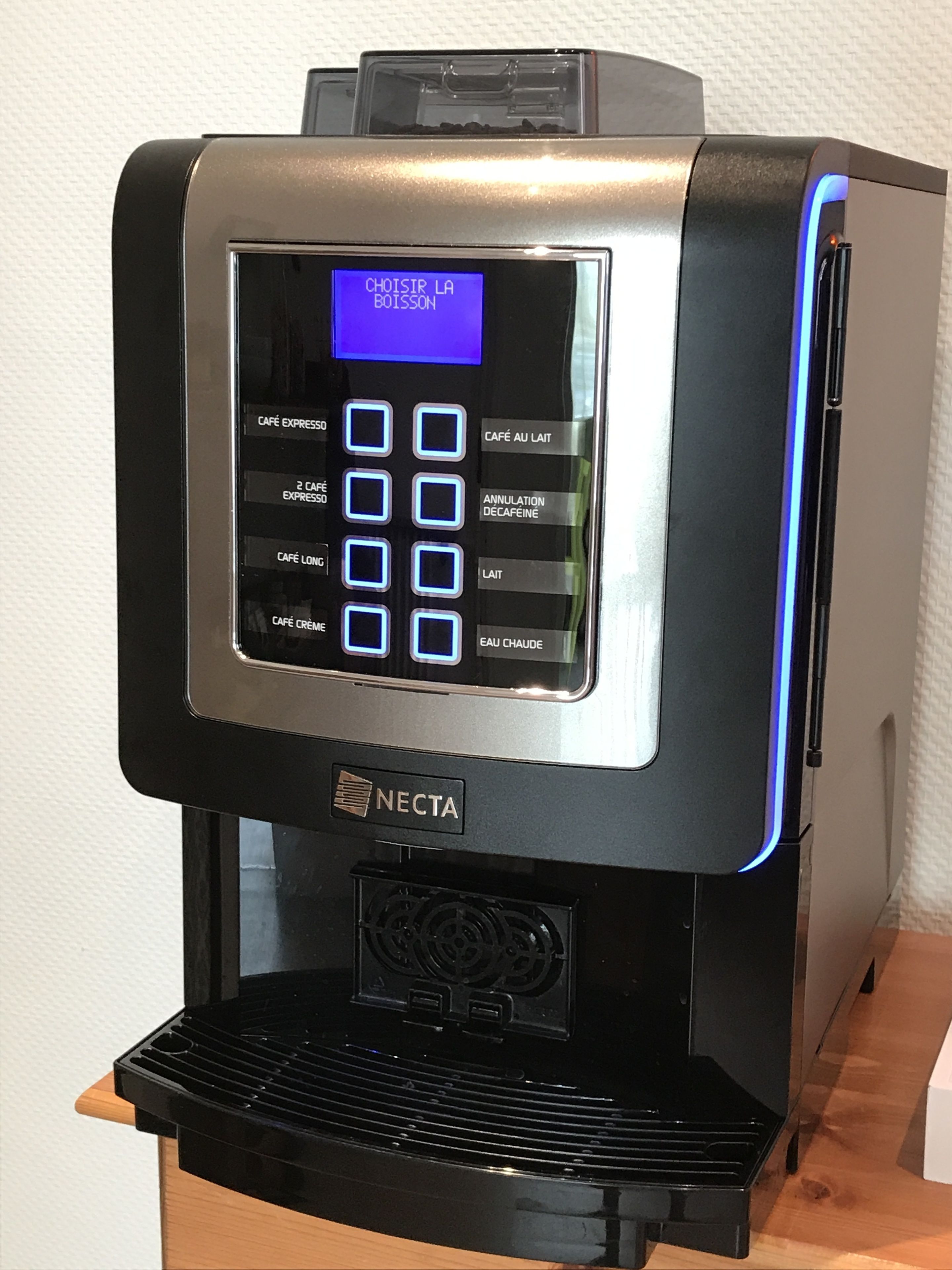 A Necta coffee machine with a digital display and multiple coffee options.