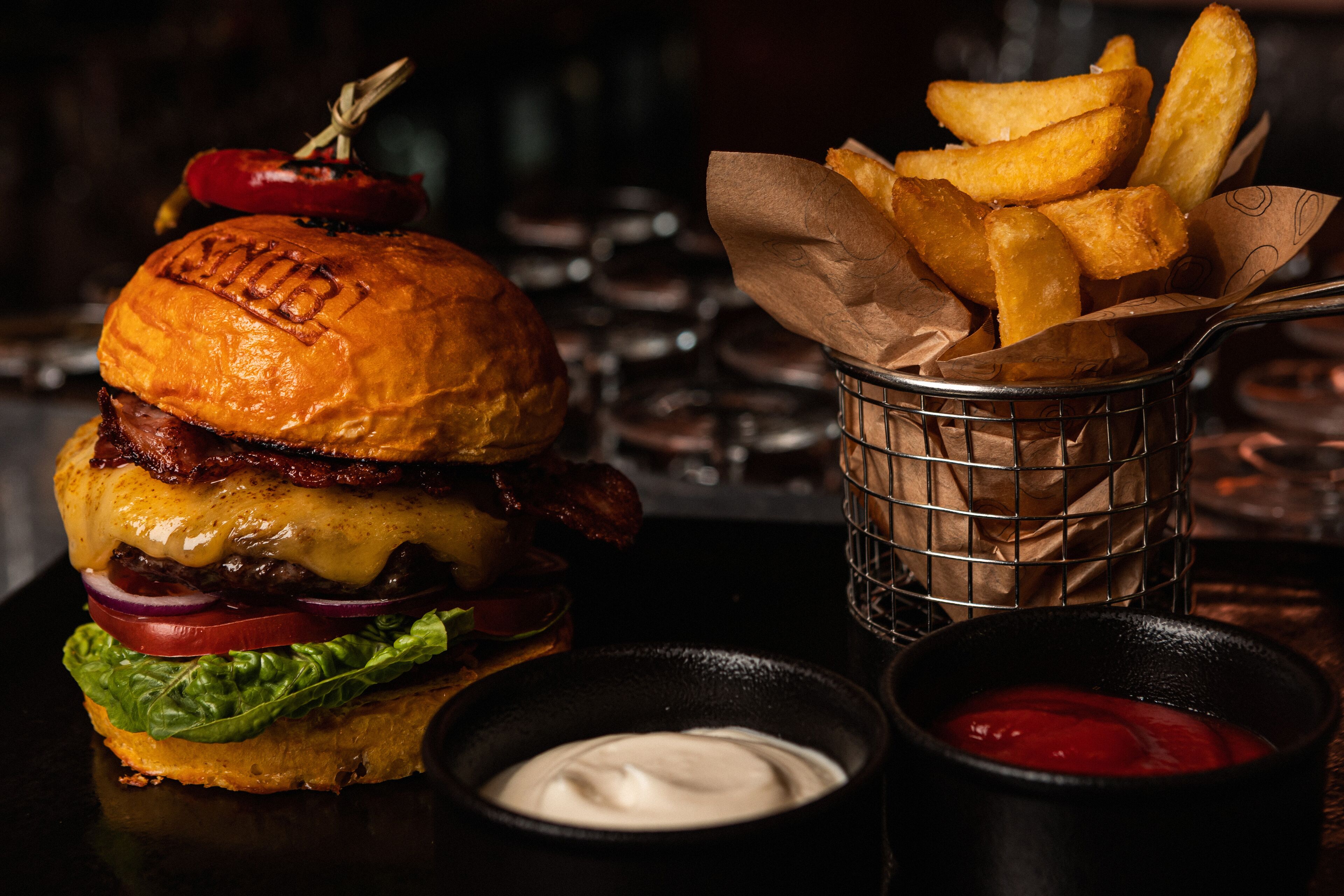 A burger with fries and ketchup.