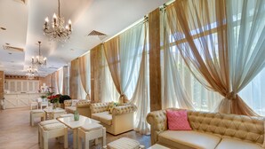 A spacious hotel lobby with a reception area, multiple seating options, and large windows with sheer curtains. - Apart-hotel Dawn Park (Sunny Beach)