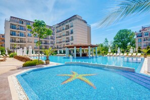 A swimming pool with a starfish design, surrounded by lounge chairs and a gazebo. - Apart-hotel Dawn Park (Sunny Beach)