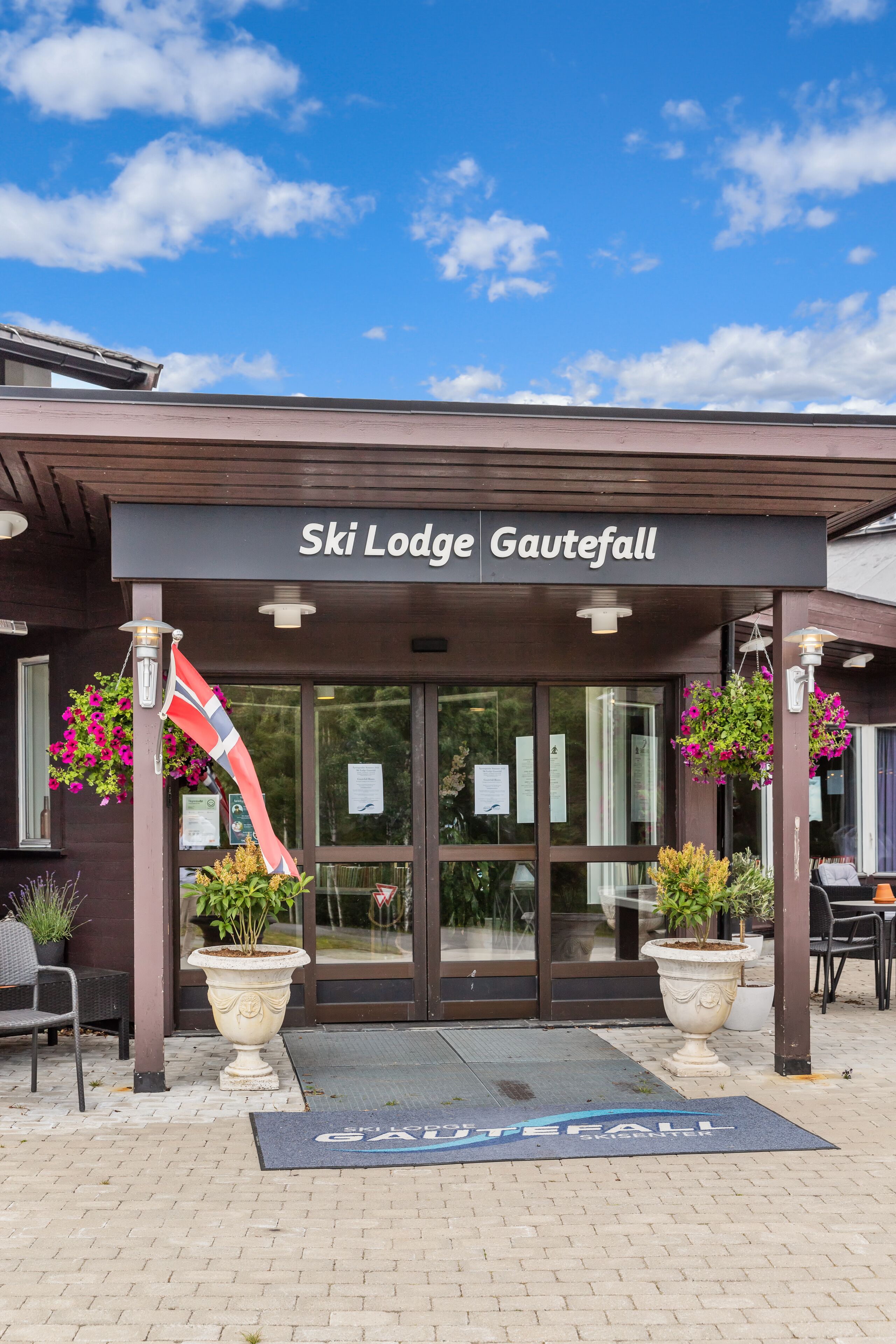 The entrance to Ski Lodge Gawaitfall with a clear sky above.