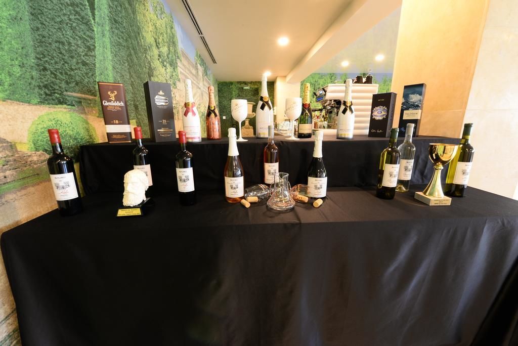 A table with various wine bottles and glasses, likely for a tasting event.