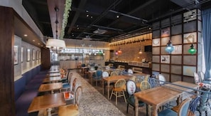A restaurant interior with booths, tables, and hanging lights. - Vienna Int Hotel Shenzhen Tian'an Digital City (Shenzhen)