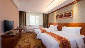 A hotel room with two beds, a desk, a chair, a television, and a painting on the wall. - Vienna International Hotel (Shanghai)