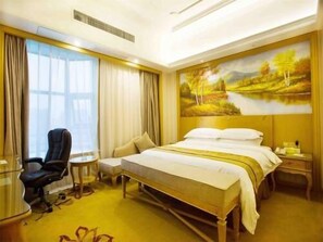 A hotel room with a bed, a desk, a chair, a painting on the wall, and a window with curtains. - Vienna International Hotel (Shanghai)