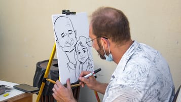 A person drawing on a whiteboard with a black marker.