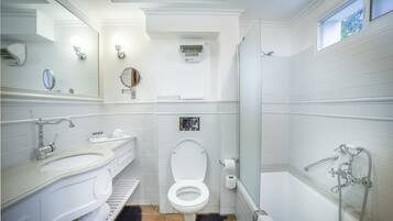 Une salle de bain moderne avec un lavabo blanc, un meuble-lavabo, des toilettes et une baignoire.