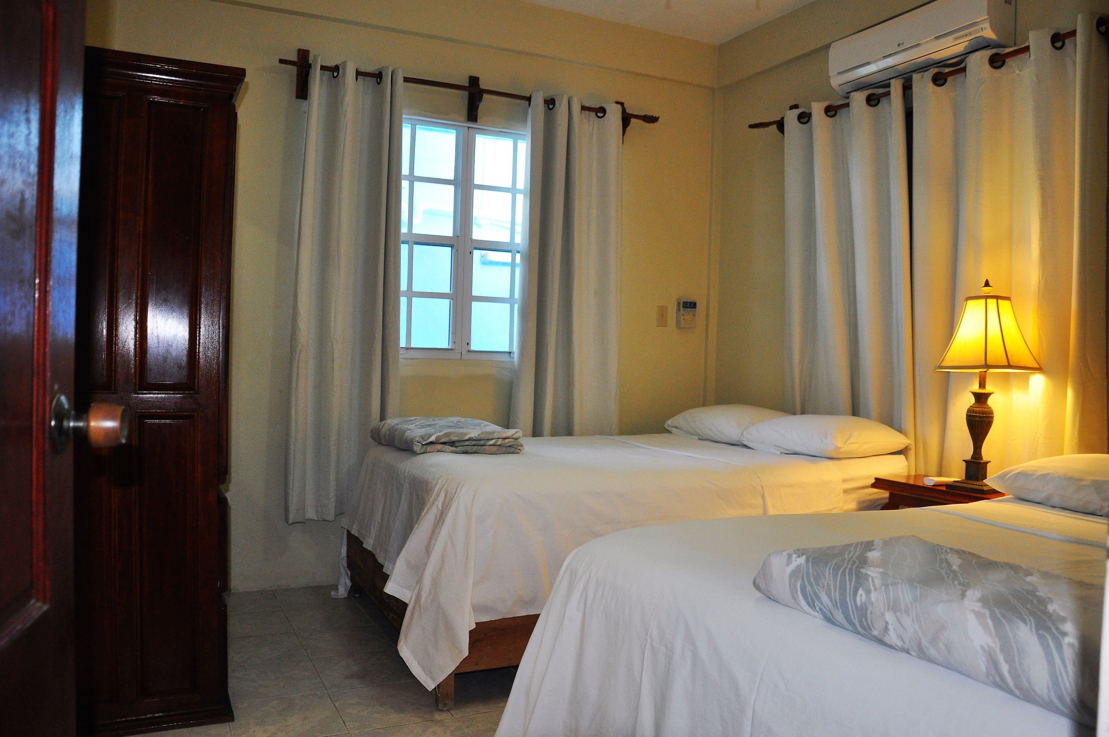 deluxe suite, 2 queen beds, sea view | in-room safe, desk, iron/ironing board, free wifi