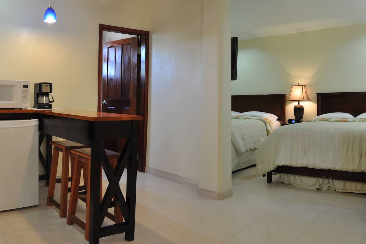 deluxe suite, 2 queen beds, sea view | in-room safe, desk, iron/ironing board, free wifi