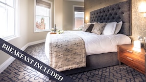 A bedroom with a large bed, a headboard, a nightstand, and a window with a view of a building. Breakfast is included. - Shipquay Boutique Hotel (Londonderry)
