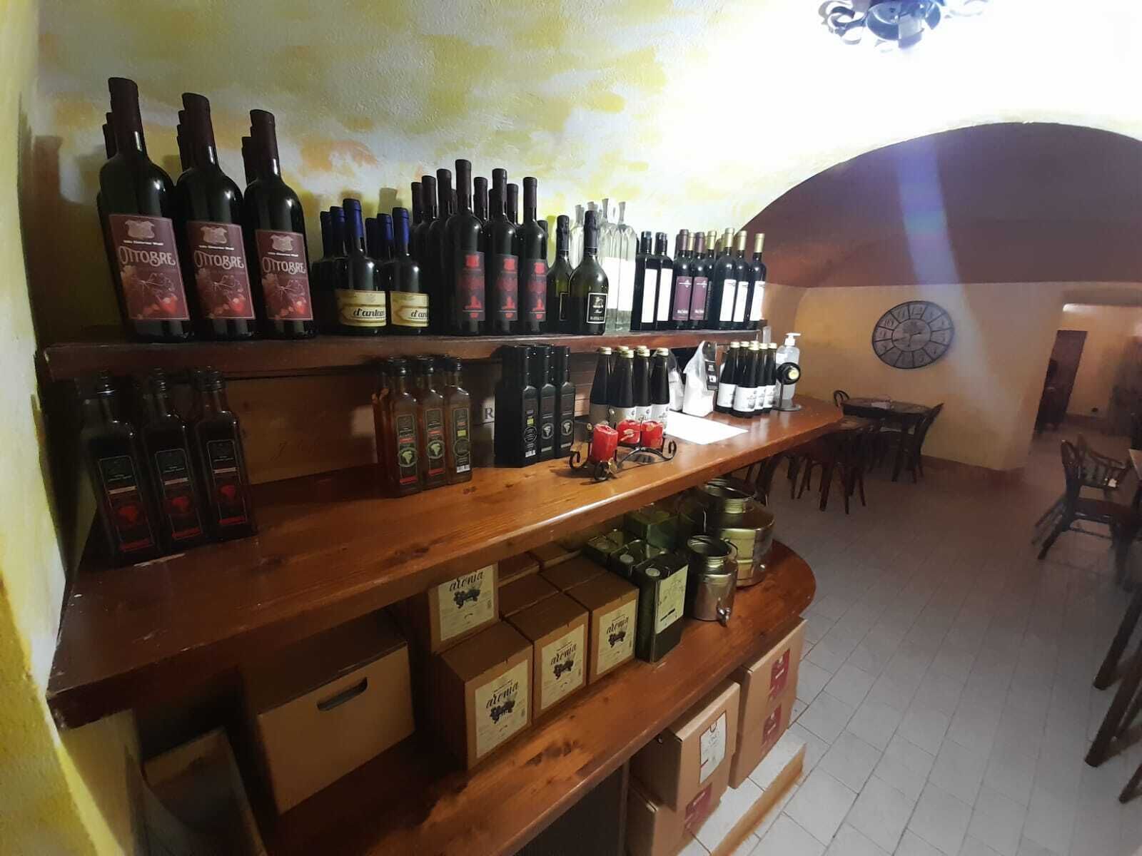 Una cava llena de estantes con diversas botellas y cajas de vino.