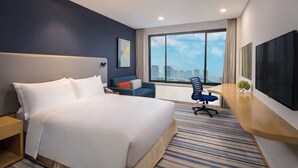 A hotel room with a large bed, a desk with a chair, a TV, and a window with a city view. - Holiday Inn Express Wuxi Taihu New City by IHG (Wuxi)
