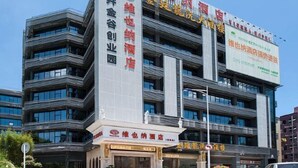 A multi-story hotel with a modern architectural design, featuring a prominent signboard with Chinese characters. - Vienna Hotel (Shenzhen Longzhu) (Shenzhen)