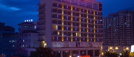 A multi-story hotel with a prominent sign at the top.