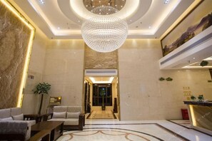 A hotel lobby with a chandelier, seating area, and a reception desk. - Vienna Hotel (Sanya Bay) (Sanya)