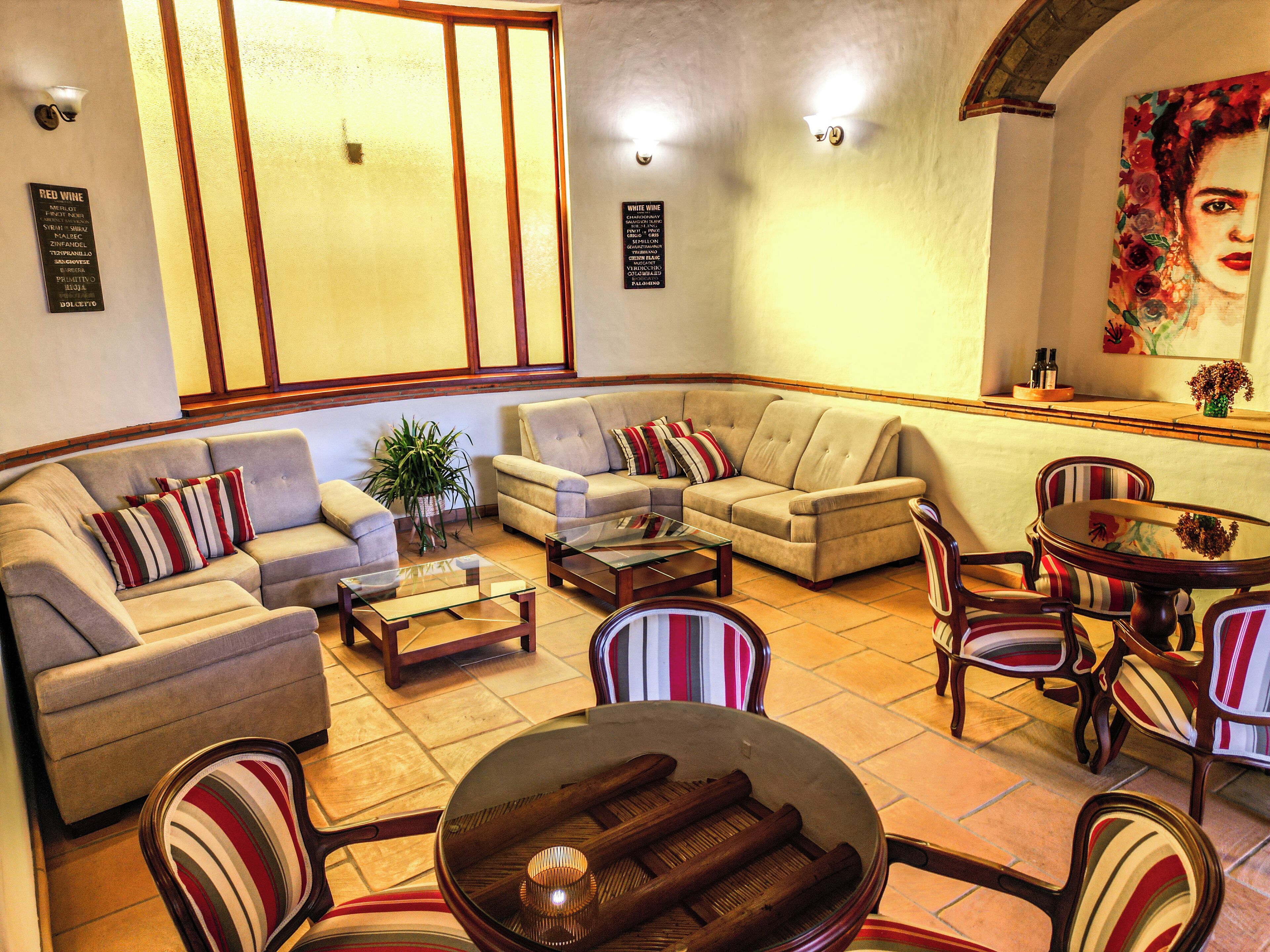 A spacious living area with a sofa set, a coffee table, and striped chairs.