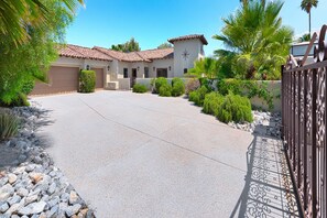 Una propiedad residencial con garaje, entrada con camino de acceso y acceso mediante portón.