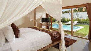Quarto com cama, televisão e vista para uma piscina.