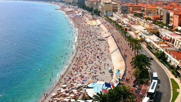 A coastal cityscape with a wide beach, a promenade lined with buildings, and a clear view of the sea. - Perfect place to escape from routine in the heights of Nice (Nice)