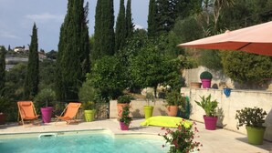 A swimming pool with lounge chairs and potted plants. - Perfect place to escape from routine in the heights of Nice (Nice)