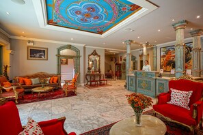 A luxurious hotel lobby with ornate decor, a grand chandelier, and a marble floor. - At Pingnakorn Riverside Hotel Chiangmai (Chiang Mai)