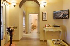 Stroll through our inviting corridor, lined with a framed cityscape and a vase of fresh flowers.